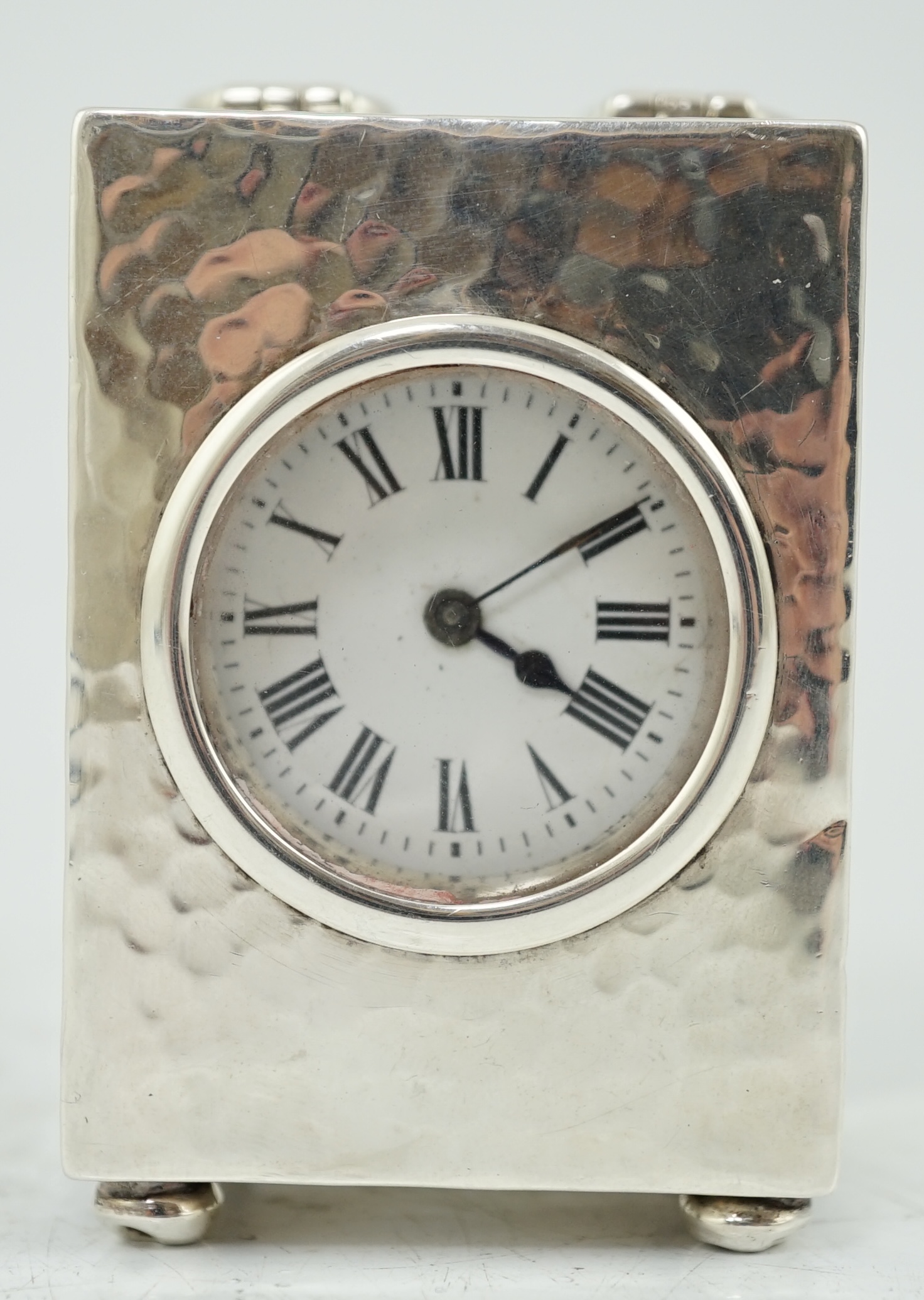 An Edwardian planished silver miniature carriage timepiece, by Arthur Baume & Co